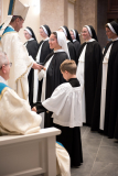 Bishop Spalding gives each sister a black veil, a sign of their consecration and renunciation of the world.