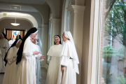 31-Many of the professed sisters can be seen jotting down the sister's new name.