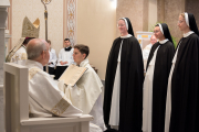 18-Bishop Spalding, seated, prays for the sisters who professed their vows.