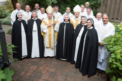 Before Mass, Bishop Spalding, priest concelebrants, Mother Anna Grace, and the sisters to profess their perpetual vows pose for a photograph. Before Mass, Bishop Spalding, priest concelebrants, Mother Anna Grace, and the sisters to profess their perpetual vows pose for a photograph.