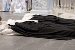 During the singing of the Litany of Saints, the sisters prostrate before the altar as a sign of their complete gift of self to Christ. During the singing of the Litany of Saints, the sisters prostrate before the altar as a sign of their complete gift of self to Christ.