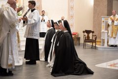 The sisters kneel before the Bishop. The sisters kneel before the Bishop.