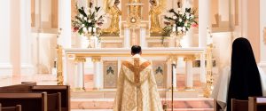 Father in adoration before the Blessed Sacrament