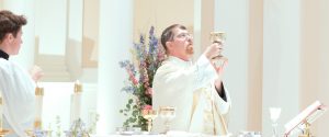 Father lifts the chalice at the offertory