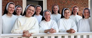 smiling Dominican Sisters on porch