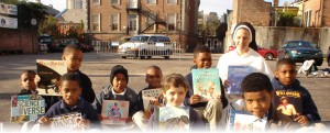 children with new books stand with Dominican Sister